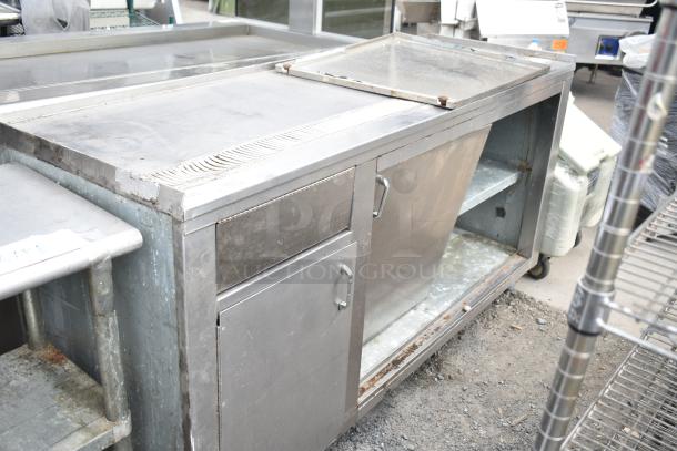 Commercial soda station with under shelves and doors, stainless steel, used condition, sturdy with visible wear.