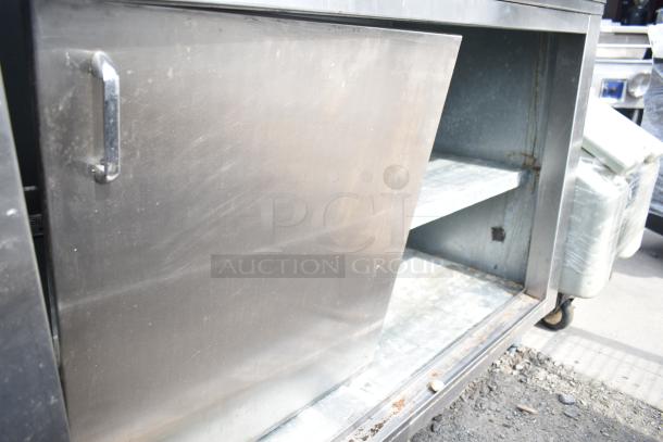 Commercial soda station with under shelves and doors, stainless steel, showing wear and rust, suitable for beverage service.