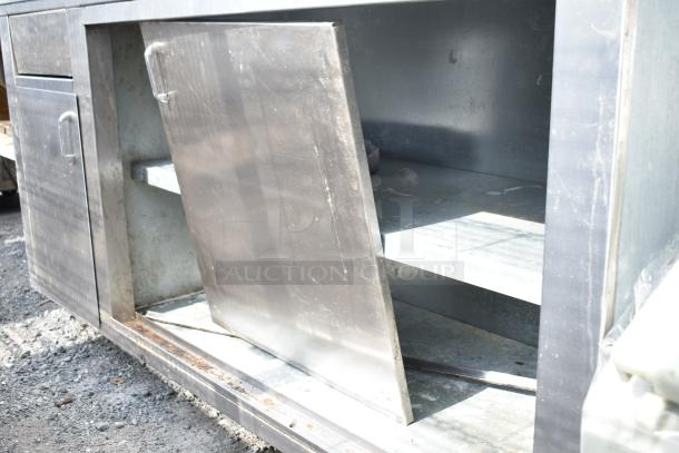 Commercial soda station with under shelves and doors, showing light wear and some rust. Stainless steel construction.