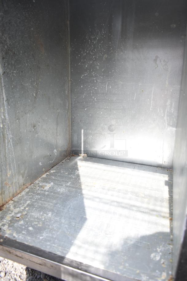 Commercial soda station interior with visible wear, featuring under shelves and doors. Sturdy construction for restaurant use.