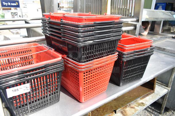 18 red and black poly baskets stacked on a metal surface, in good condition. Tag reads "185, Qty x18."