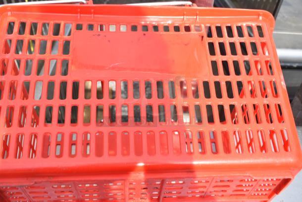 Red rectangular plastic basket with grid design, shown from the top. Used condition, durable for storage or transport.