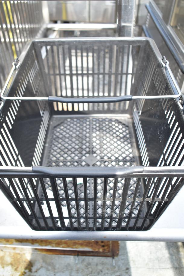 Black poly basket with metal handle, grid bottom. Set of 18 baskets, sturdy design, commercial use, excellent condition.