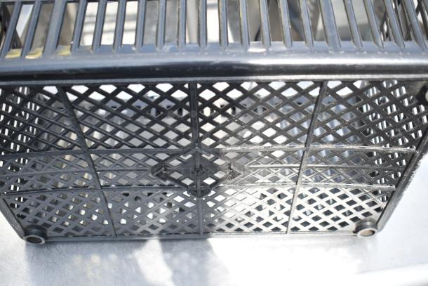 18 black poly baskets with lattice design, stackable, durable. Suitable for storage and display. Auction lot: 18 for one bid.