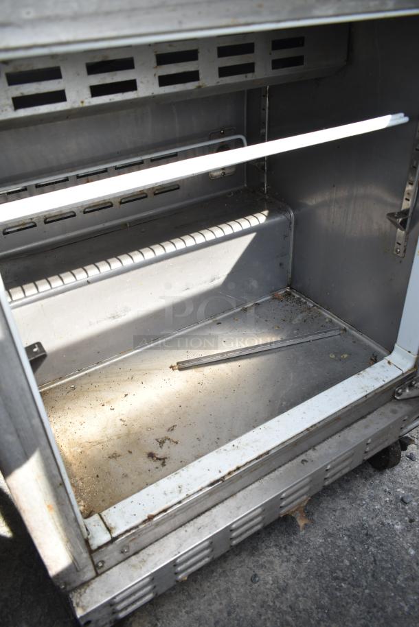 Ascend JSP-2708 prep table bain marie, 115V, 1 phase, commercial use, interior view showing metal shelves, signs of wear.