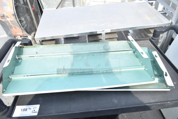 Black Poly 3 Tier Cart on commercial casters, handles on sides, used condition. Auction tag with lot number visible.