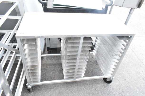 Commercial double pan transport rack with shelves, mounted on sturdy commercial casters, suitable for bakery or kitchen use.