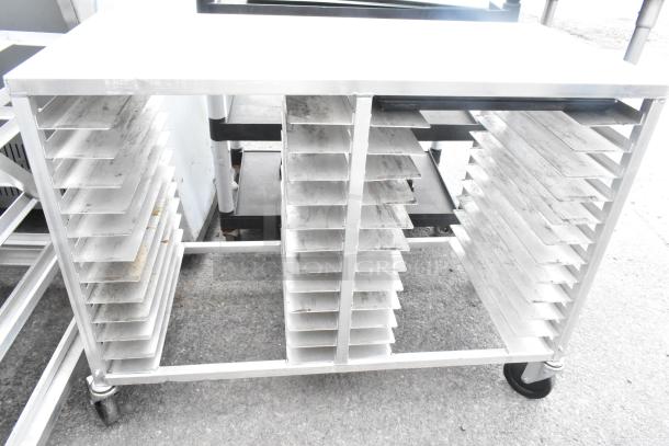 Commercial double pan transport rack with adjustable slots, on durable casters. Moderate wear, ideal for kitchen use.