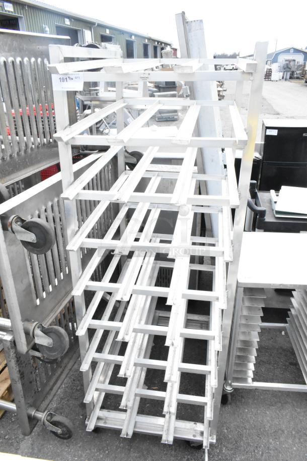 Commercial #10 can rack on casters, metal, multiple shelves, sturdy frame, auction tag visible, good condition.