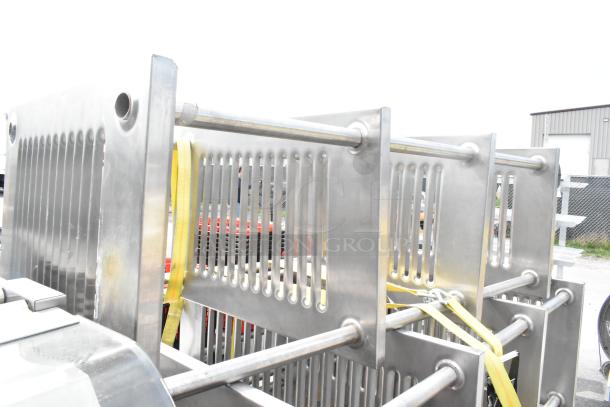 Three metal 4-tier shelving units on commercial casters, strapped for transport. Buyer must dismantle and consider freight charges.