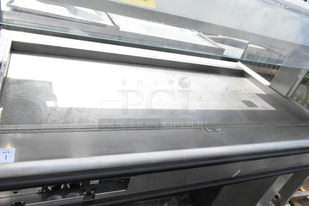 Henny Penny HMI-105 HI-5 heated island display case, 120/208V, 1 phase, glass top, stainless steel body, used condition.