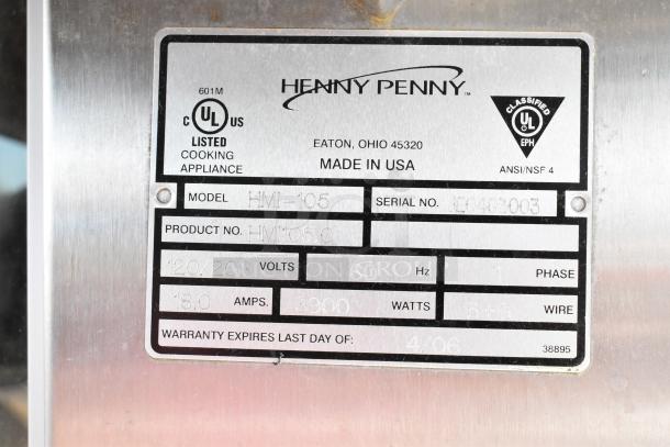 Henny Penny HMI-105 tag, showing model, serial number, voltage, phase, and warranty expiry on metal plate.