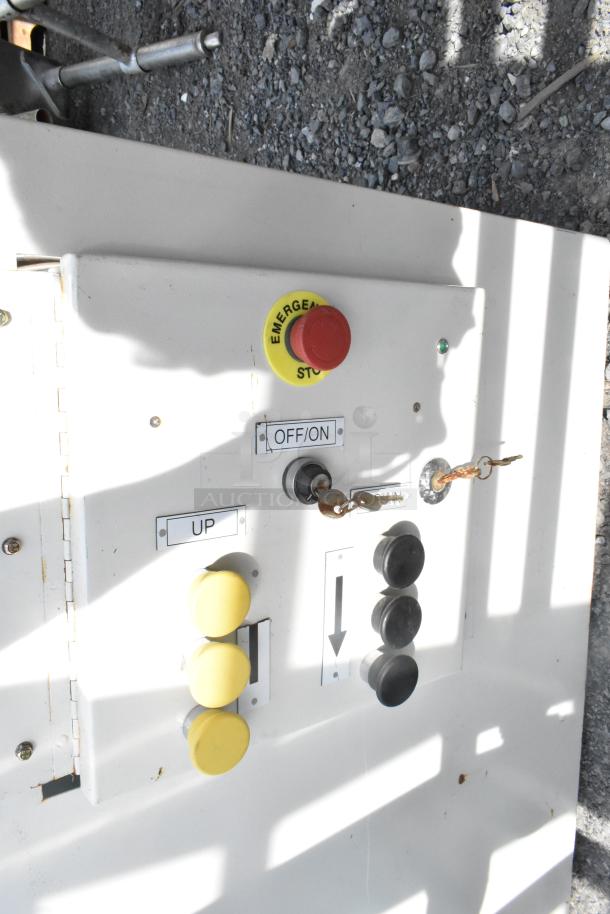 Control panel with yellow "UP" and black directional buttons, red emergency stop, and "OFF/ON" switch. Weathered condition.