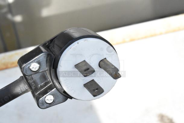 Black electrical plug with two horizontal prongs and one vertical prong. Markings show "AC 60Hz" and "15A 125V".