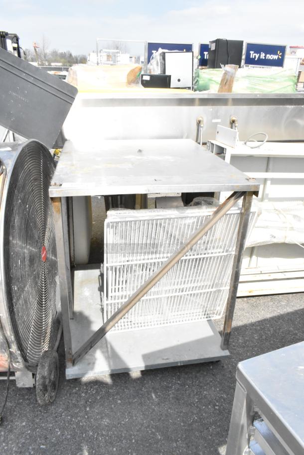 Metal table with under shelf, used condition, some surface wear. Ideal for kitchen or workshop use.