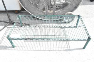 Green wire dunnage rack with slatted design, sturdy metal construction, slightly scuffed, suitable for storage.