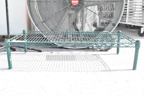 Green wire finish dunnage rack, sturdy design, ideal for storage. Good condition, suitable for commercial use.
