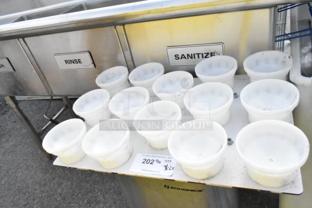 12 white plastic bowls on a Songmics trash can. Labels for wash, rinse, sanitize visible. Auction tag reads "202 2x."