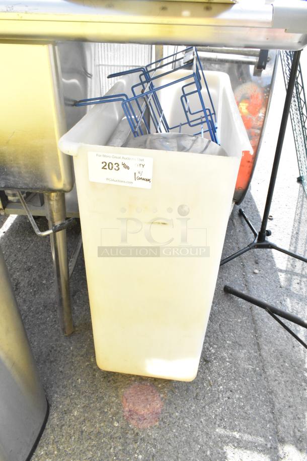 Poly trash can with contents, including blue metal racks. Condition shows signs of use. Auction label: "203 4/10."