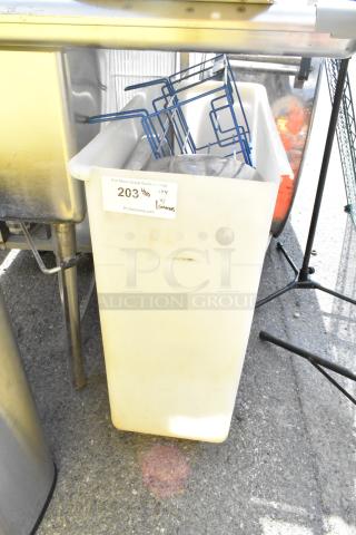 Poly trash can with contents, including blue metal racks. Condition shows signs of use. Auction label: "203 4/10."