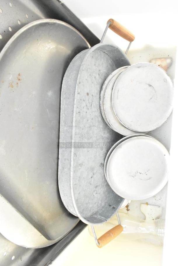 Poly trash can with metal trays and lids. Features wooden handles. Some markings and discoloration visible.