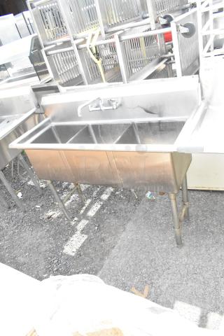 Commercial stainless steel 3 bay sink with faucet, in used condition. Ideal for kitchens or food service settings.