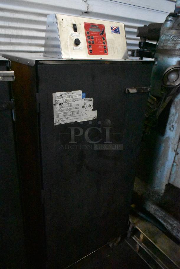 Cookshack 250 commercial electric smoker on casters, 208 volts. Features control panel, visible caution label, solid condition.