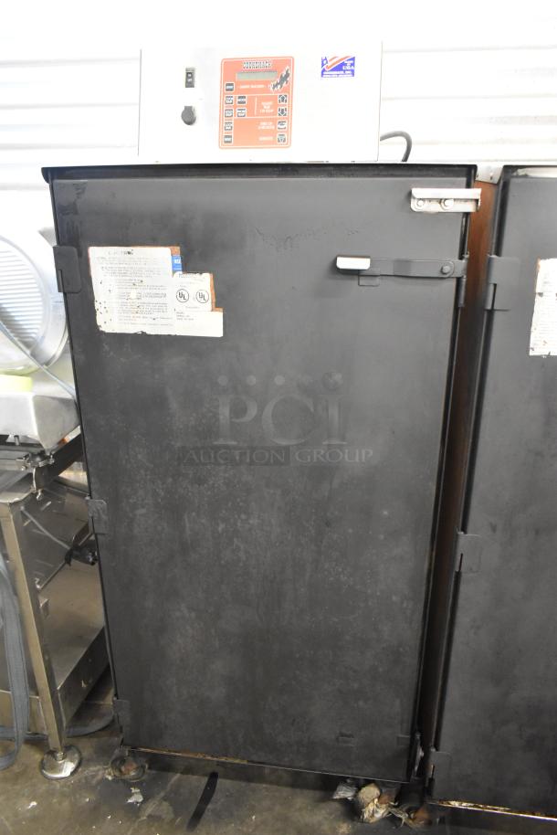 Cookshack 250 commercial electric smoker cabinet, black, with control panel and labels, on casters. 208 volts.