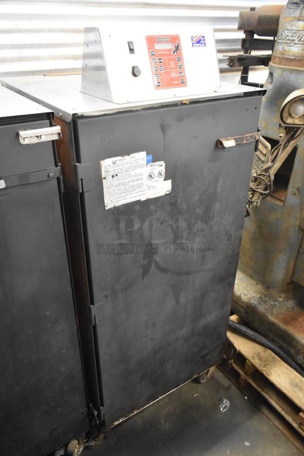 Cookshack 250 Commercial Electric Smoker, 208 volts, with control panel, commercial casters, visible use marks.