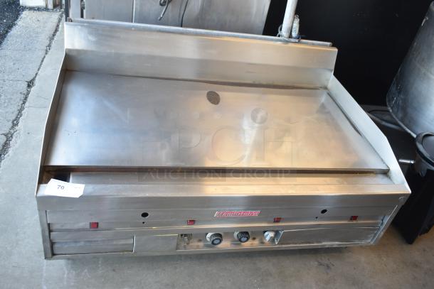 MagiKitch'n commercial countertop chrome flat top griddle in used condition with control knobs and branding visible.