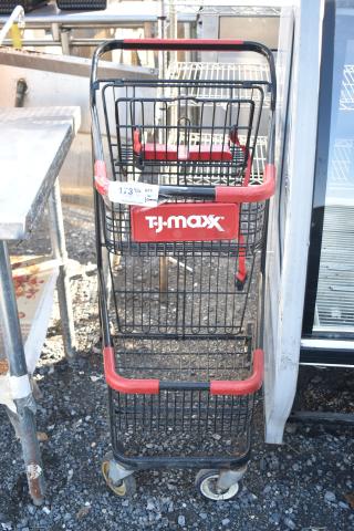 2-tier shopping cart with T.J. Maxx branding. Features red handles and sturdy metal design. Good condition, visible label.