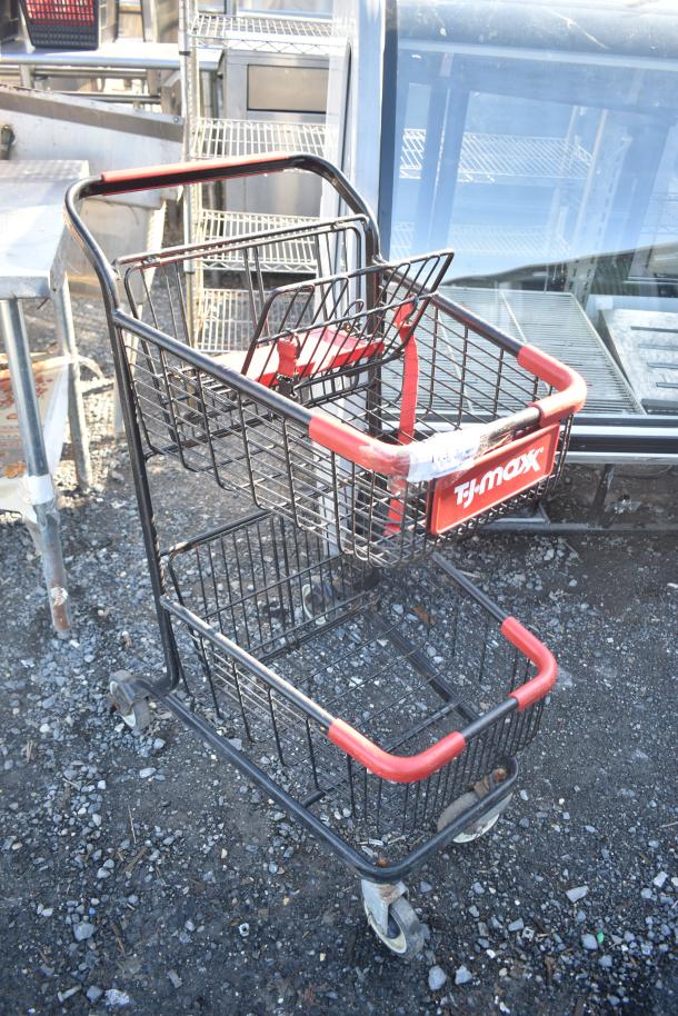2-tier shopping cart from TJ Maxx with red handles and wheels, in used condition, featuring a child seat strap.
