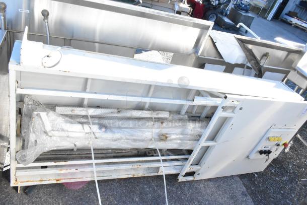 Control panel with two Telemecanique Osiswitches, white casing, bubble-wrapped components, used condition, outdoor setting.