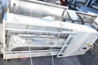 Control panel with two Telemecanique Osiswitches, white casing, bubble-wrapped components, used condition, outdoor setting.