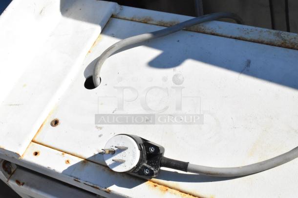 Control panel with two Telemecanique Osiswitches, showing a connected cable; visible rust and wear on the surface.