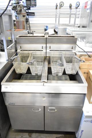 Pitco Frialator commercial gas deep fryer with dual baskets, stainless steel body, in used condition, model visible in image.