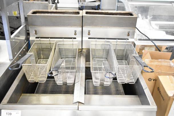 Pitco Frialator gas-powered commercial deep fat fryer with twin fry baskets. Floor style, stainless steel, used condition.