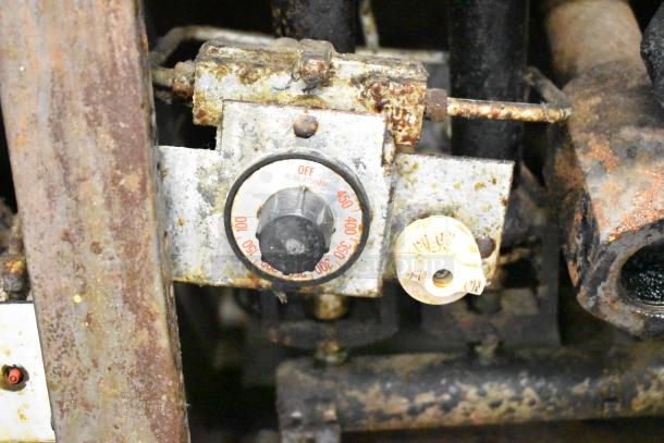 Pitco Frialator commercial gas deep fat fryer in used condition, showing rust and wear, with visible temperature dial and pilot light control.