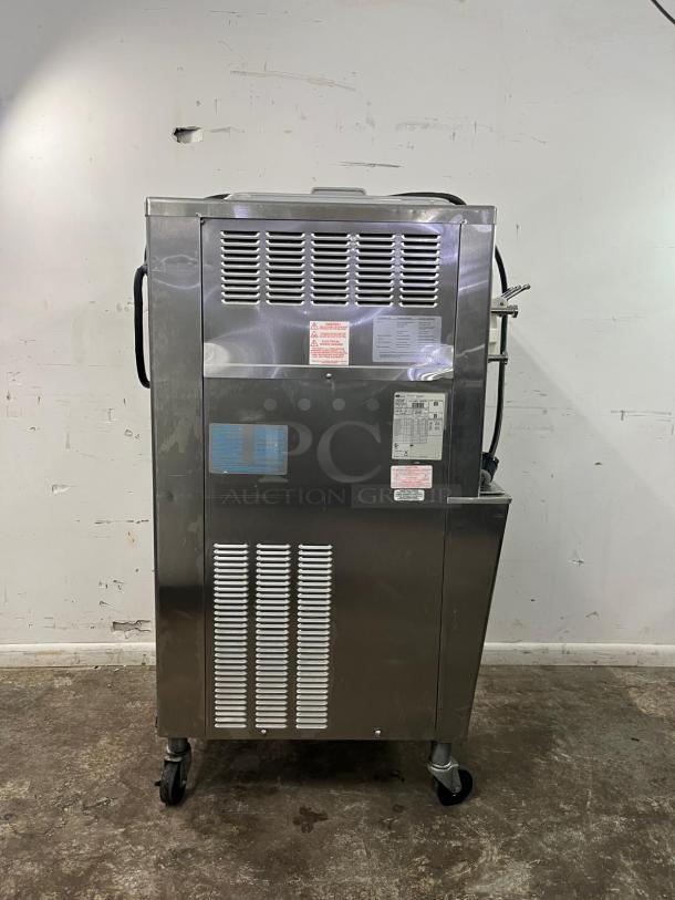TAYLOR 794-33 soft serve ice cream machine in stainless steel, displayed on casters. Visible labels with model and safety information.