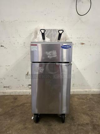 BRAND NEW Atosa ATFS-50 CookRite 50 lb gas fryer, stainless steel, 4 burners, protective wrapping visible, on wheels.