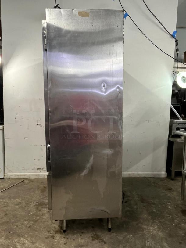 GLENCO SLA-28-S 2-door commercial freezer, stainless steel, visible wear, standing on metal legs.