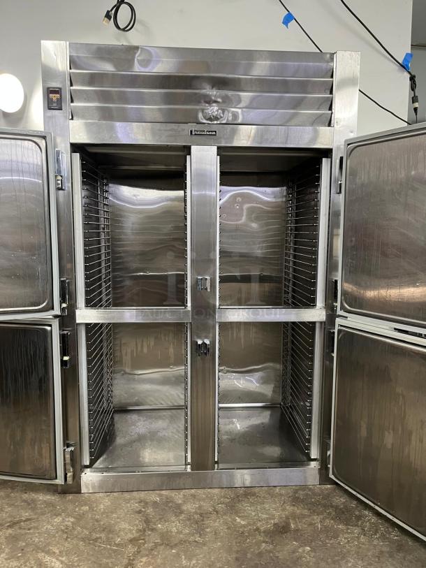 TRAULSEN RHT232NUT-HHS 46 Cu. Ft. stainless steel reach-in refrigerator, two-section, half door, excellent condition.