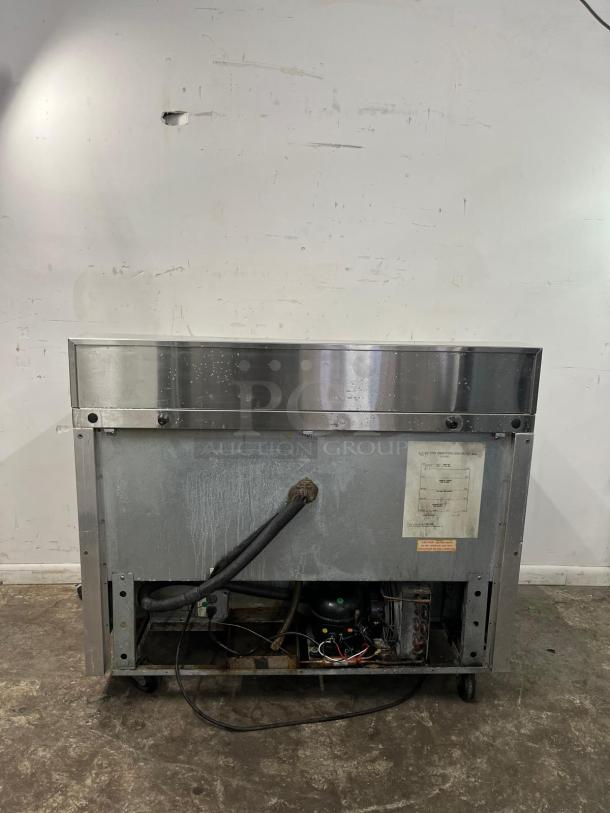 Continental SW48-12 Refrigerated Sandwich Prep Unit, 48" width, 13.4 cu ft, visible wiring, and power components, used condition.