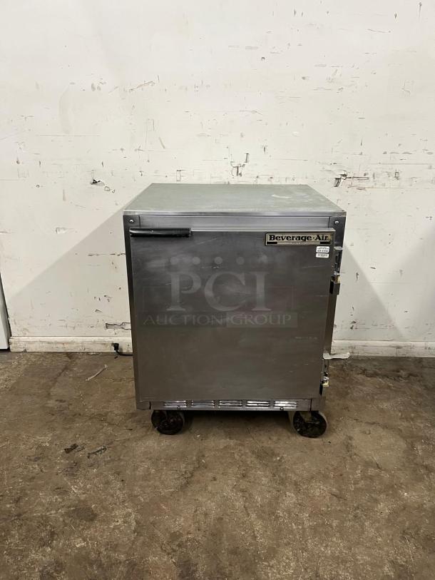 Beverage-Air 27" undercounter refrigerator, stainless steel, moderate wear. Features a front handle and visible brand label.