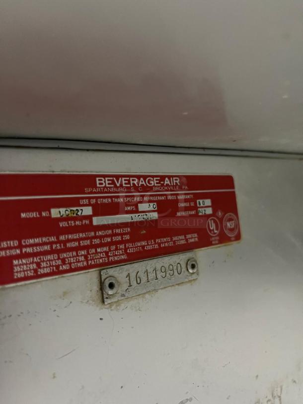 Beverage-Air undercounter refrigerator label showing model LR27 and serial number 1611990. Red and white text details specs.