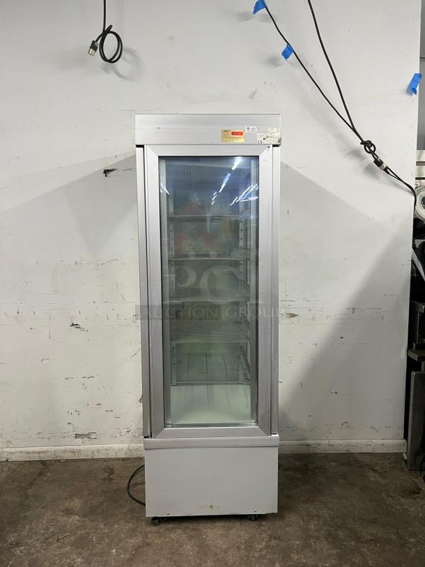 TEKNA 4400 NFP glass refrigerated display case, four-sided, good condition, visible labeling, used for showcasing items.