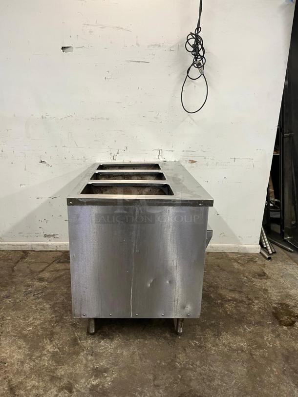 RANDELL 3513-120 48" electric hot food table with three top openings, stainless steel, visible wear, cords hanging above.