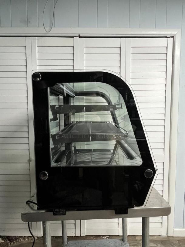 YUKON RTW-160 refrigerated display case, curved glass, countertop model, features shelf racks, sleek black finish, excellent condition.