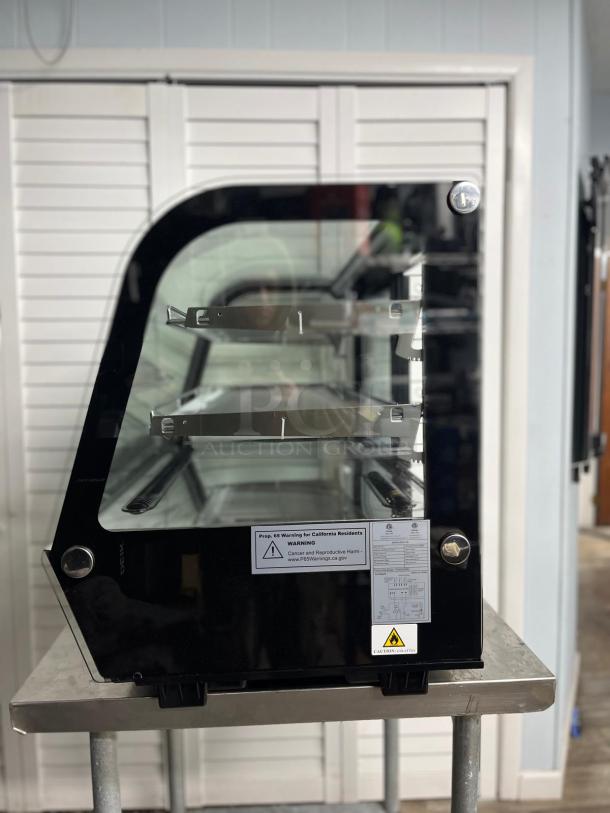 YUKON RTW-160 countertop refrigerated display case with curved glass, two shelves, black frame, and warning labels visible.