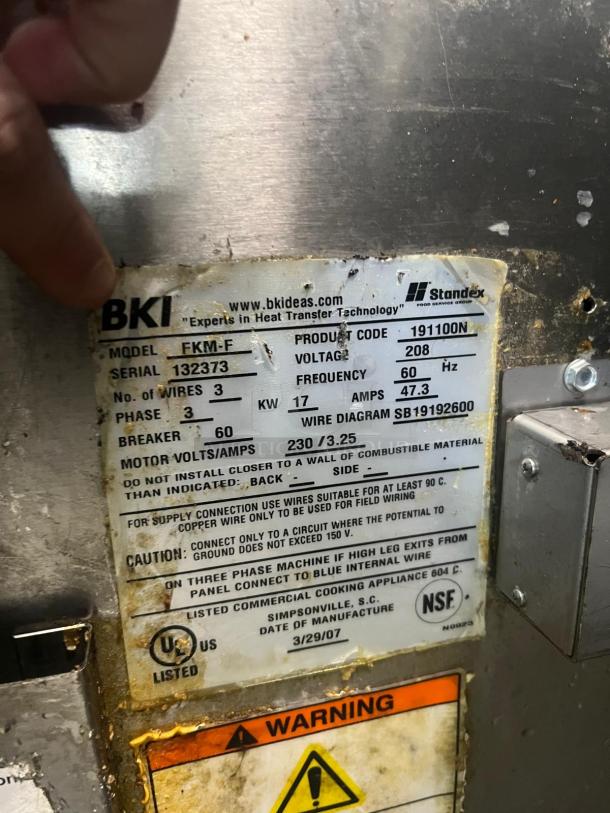 BKI FKM-F electric pressure fryer, 24-inch, manual control, extra-large volume. Model tag shows specs and caution labels.